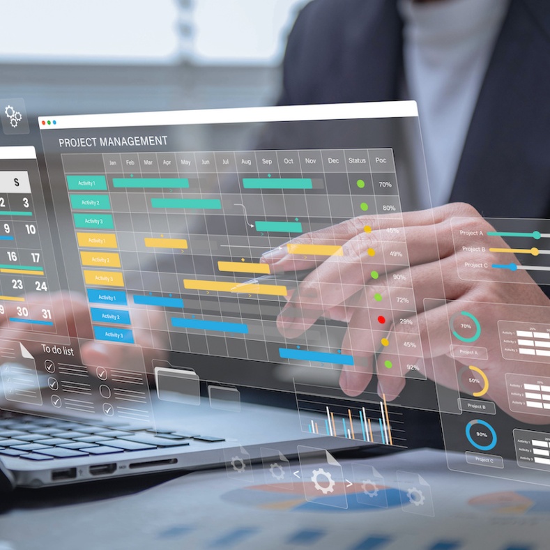 Business professional interacting with a futuristic digital interface displaying project management tools, including Gantt charts, calendars, progress bars, and task lists.
