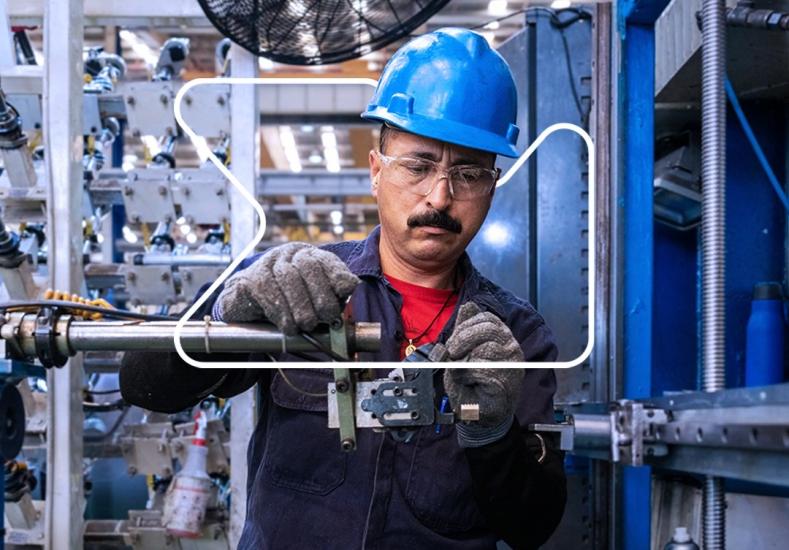 Man hardhat working on part.jpg