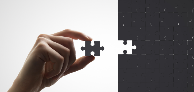 Hand inserts missing piece of the puzzle